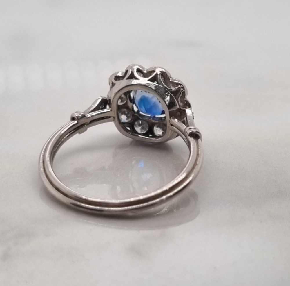 Art-Deco style sapphire and diamond cluster engagement ring in platinum