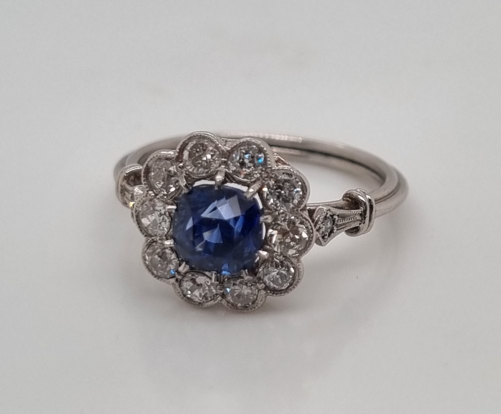 Art-Deco style sapphire and diamond cluster engagement ring in platinum