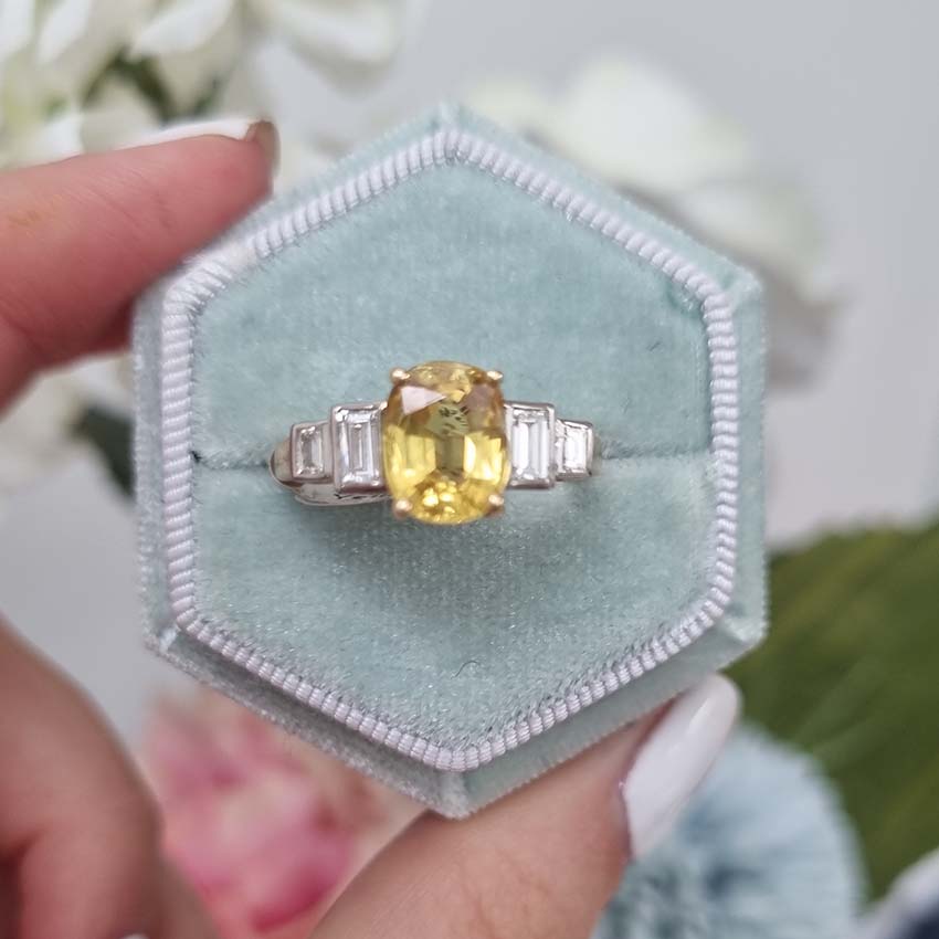 2.41ct Yellow Sapphire Engagement Ring with Baguette Diamonds, 2.41ct oval yellow sapphire flanked by stepped baguette-cut diamond shoulders in 18ct yellow gold