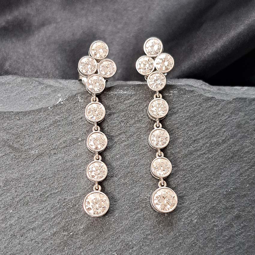 Quatrefoil 3.60ct Diamond Drop Earrings, quatrefoil tops suspend four gently graduating diamonds all bezel set in 18ct white gold