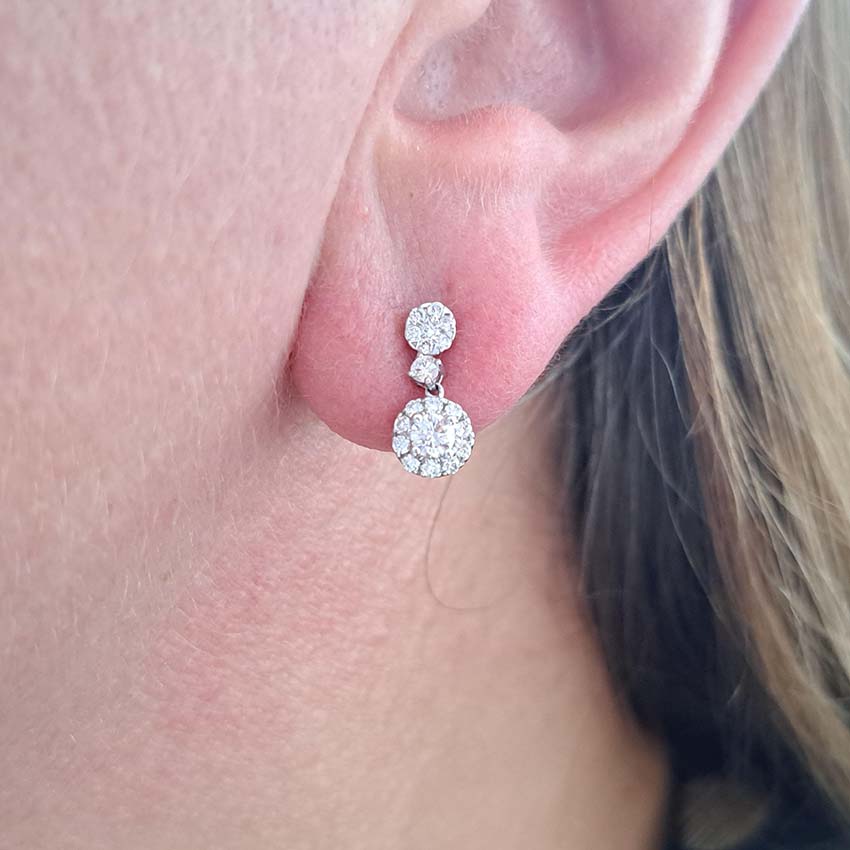 Diamond Double Cluster Drop Earrings, 0.66 carats, circular diamond cluster stud tops suspend diamond cluster pendant drops via solitaire diamond links in 18ct white gold