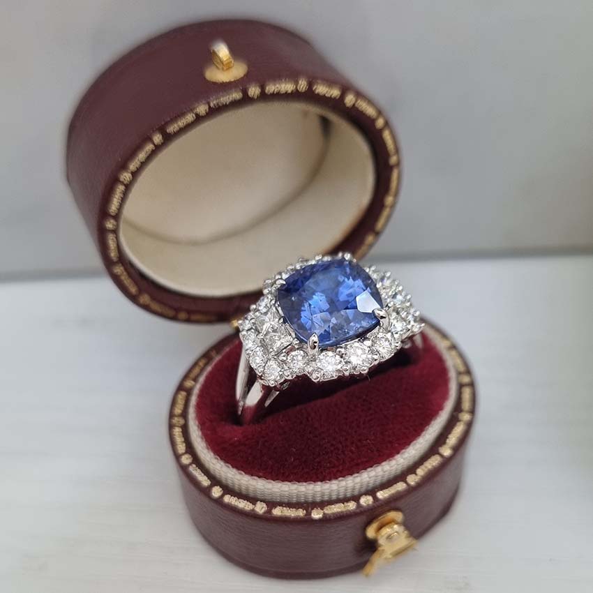 Oval Cushion Shaped Sapphire and Diamond Cluster Engagement Ring in 18ct white gold with split shoulders