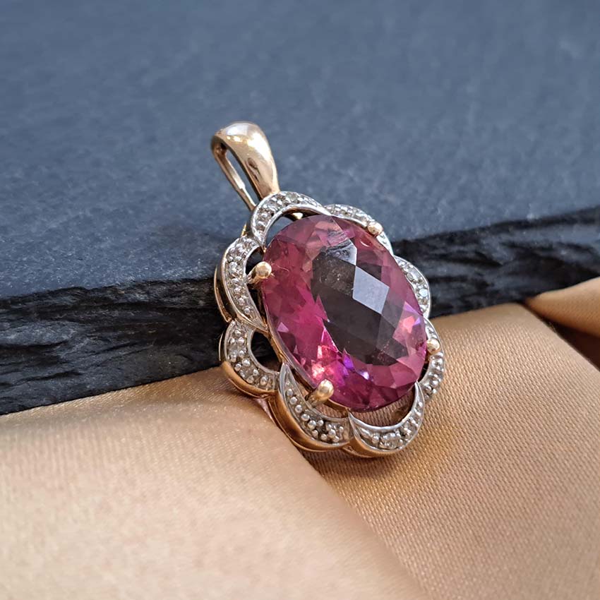Pink Topaz and Diamond Cluster Pendant, 11.04ct oval pink topaz set within a scrolled floral surround accented with diamonds in 14ct yellow gold