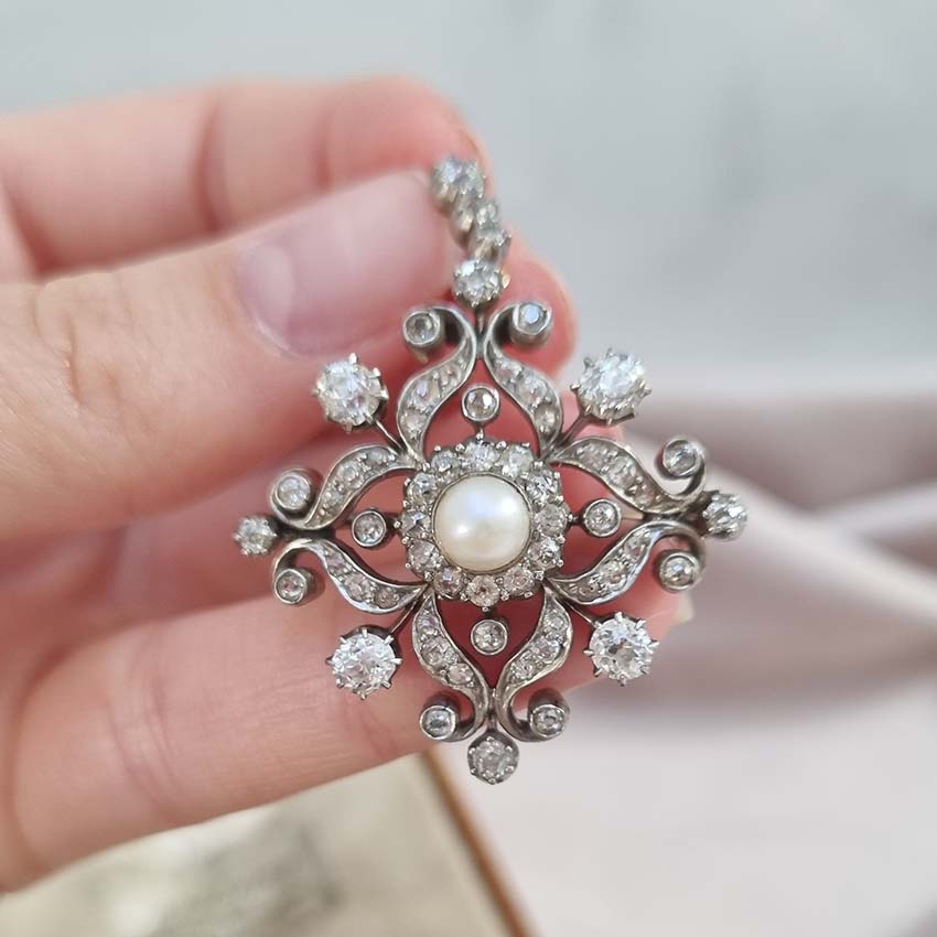 Victorian Antique Natural Pearl and Diamond Pendant come Brooch, central natural pearl surrounded by sparkling diamond in floral cluster design Presented in antique fitted box.