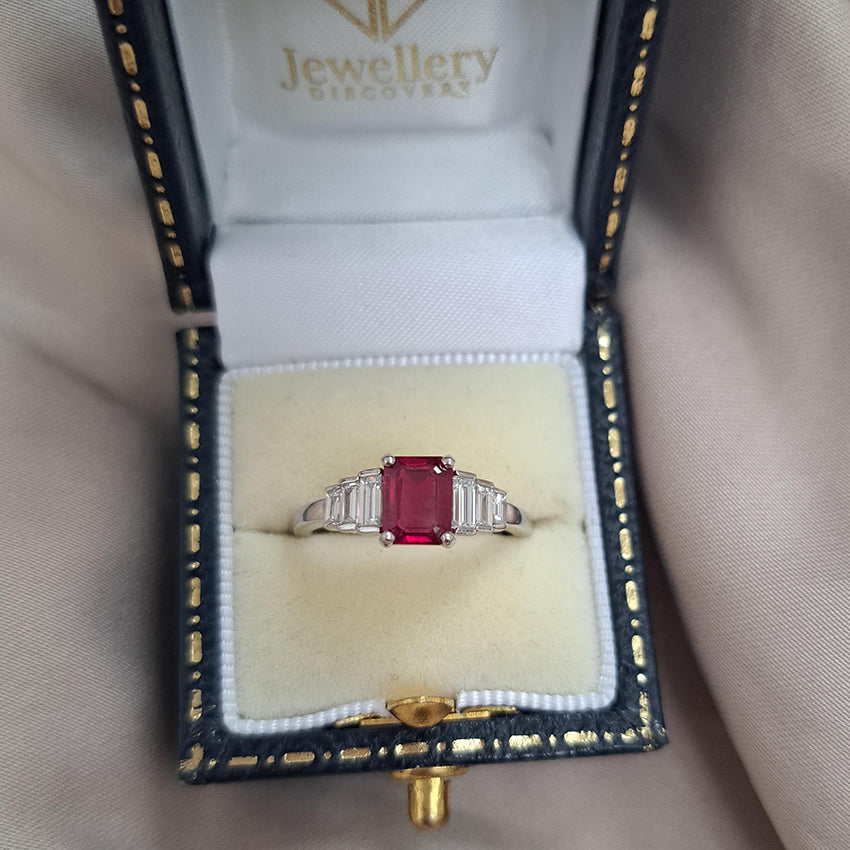 1ct Burma Ruby and Baguette Diamond Engagement Ring, 1.07ct emerald-cut Burmese ruby flanked with graduated stepped baguette-cut diamonds in platinum