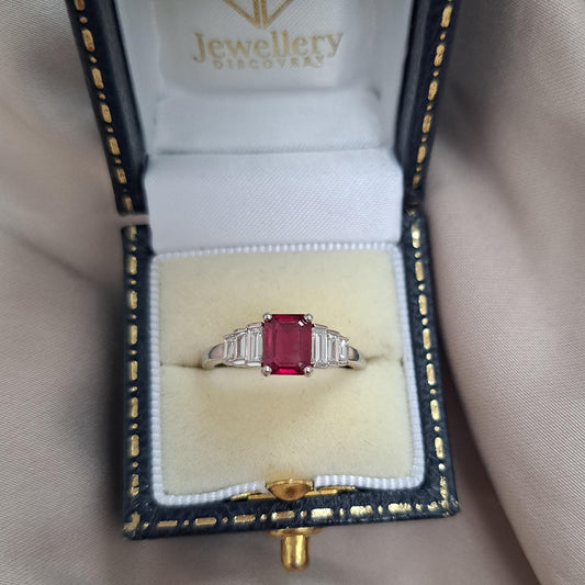 1ct Burma Ruby and Baguette Diamond Engagement Ring, 1.07ct emerald-cut Burmese ruby flanked with graduated stepped baguette-cut diamonds in platinum