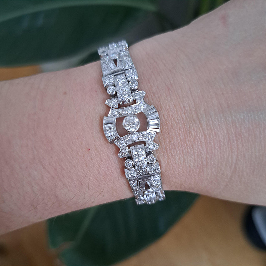 Art Deco Diamond Bracelet in Platinum, set with a geometric design of old-cut and baguette-cut diamonds. Secured with a decorative hidden clasp