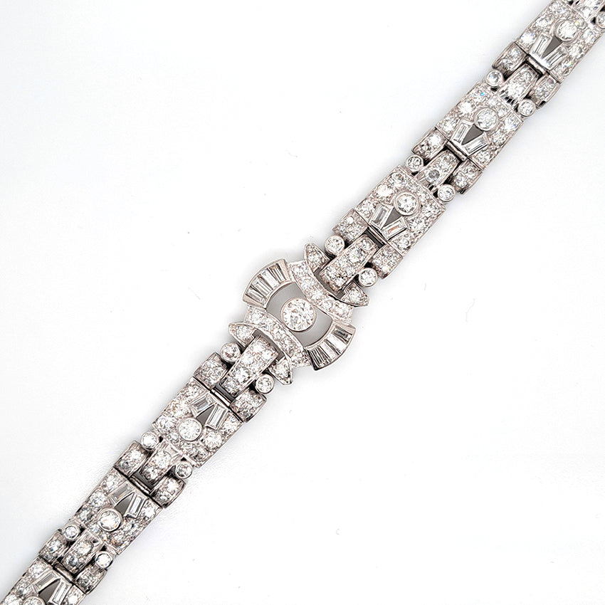 Art Deco Diamond Bracelet in Platinum, set with a geometric design of old-cut and baguette-cut diamonds. Secured with a decorative hidden clasp