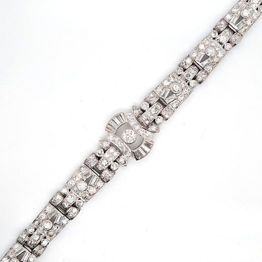 Art Deco Diamond Bracelet in Platinum, set with a geometric design of old-cut and baguette-cut diamonds. Secured with a decorative hidden clasp