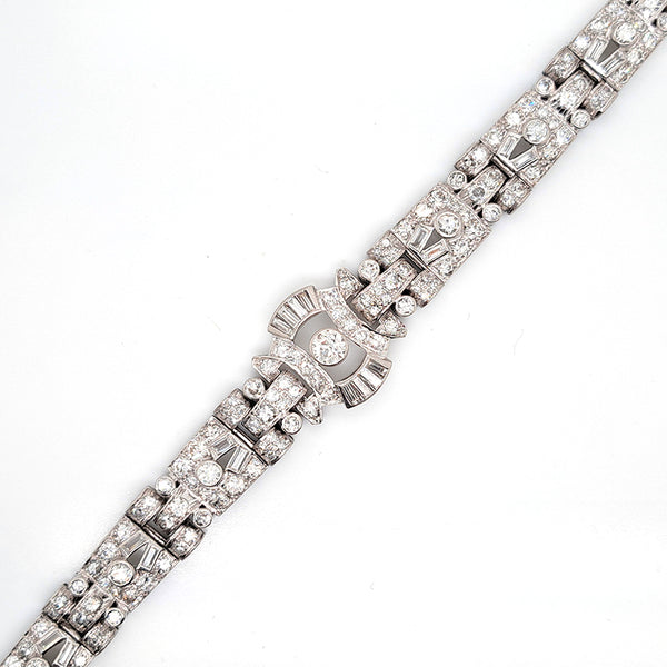 Art Deco Diamond Bracelet in Platinum, set with a geometric design of old-cut and baguette-cut diamonds. Secured with a decorative hidden clasp