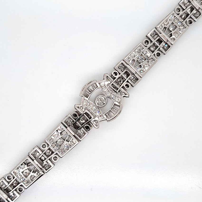 Art Deco Diamond Bracelet in Platinum, set with a geometric design of old-cut and baguette-cut diamonds. Secured with a decorative hidden clasp