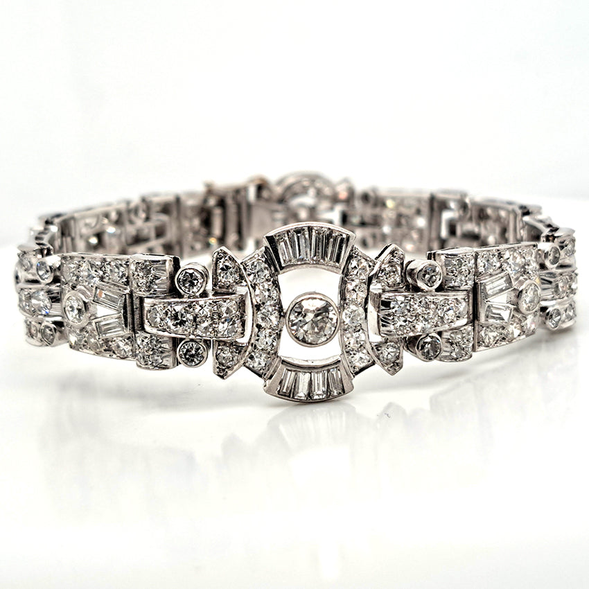 Art Deco Diamond Bracelet in Platinum, set with a geometric design of old-cut and baguette-cut diamonds. Secured with a decorative hidden clasp