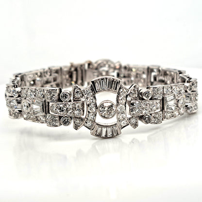 Art Deco Diamond Bracelet in Platinum, set with a geometric design of old-cut and baguette-cut diamonds. Secured with a decorative hidden clasp