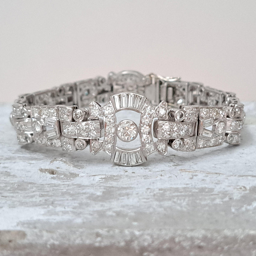 Art Deco Diamond Bracelet in Platinum, set with a geometric design of old-cut and baguette-cut diamonds. Secured with a decorative hidden clasp
