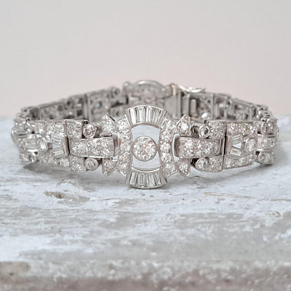 Art Deco Diamond Bracelet in Platinum, set with a geometric design of old-cut and baguette-cut diamonds. Secured with a decorative hidden clasp