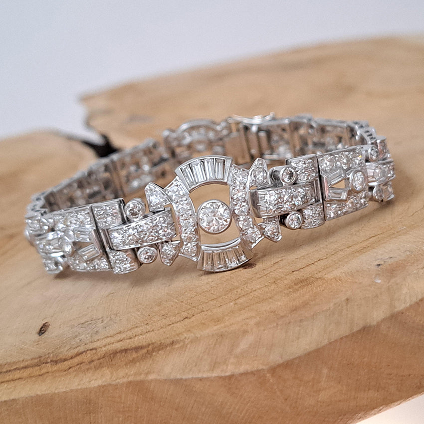 Art Deco Diamond Bracelet in Platinum, set with a geometric design of old-cut and baguette-cut diamonds. Secured with a decorative hidden clasp