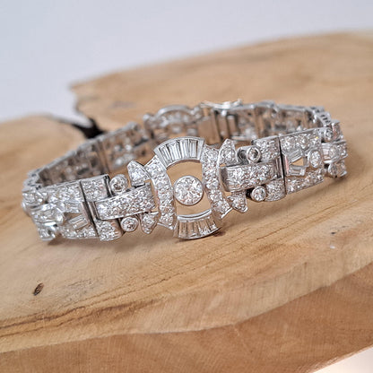 Art Deco Diamond Bracelet in Platinum, set with a geometric design of old-cut and baguette-cut diamonds. Secured with a decorative hidden clasp