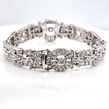 Art Deco Diamond Bracelet in Platinum, set with a geometric design of old-cut and baguette-cut diamonds. Secured with a decorative hidden clasp