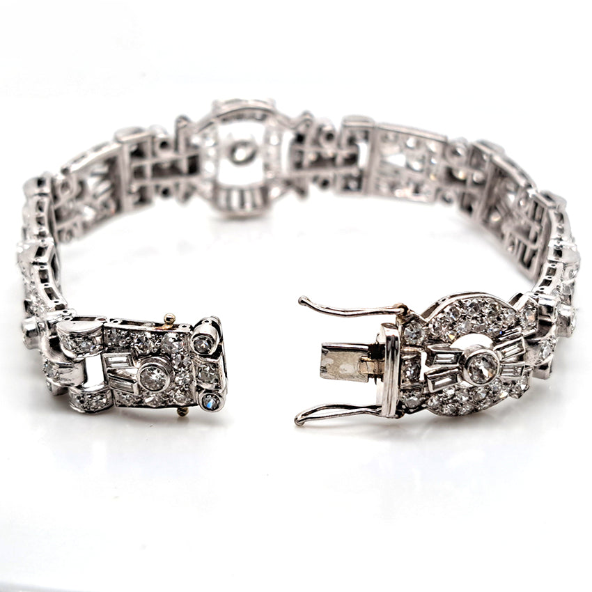 Art Deco Diamond Bracelet in Platinum, set with a geometric design of old-cut and baguette-cut diamonds. Secured with a decorative hidden clasp