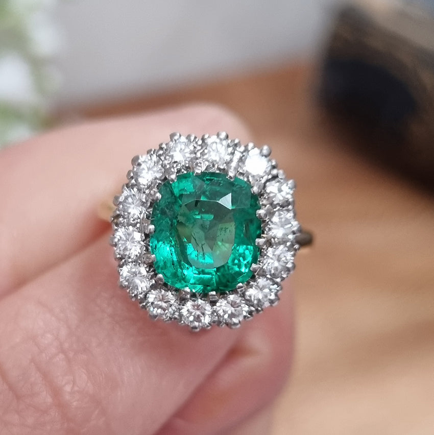 Vintage 2ct Emerald and Diamond Cluster Engagement Ring, 2ct cushion-cut emerald surrounded by 0.84cts round brilliant-cut diamonds in 18ct gold