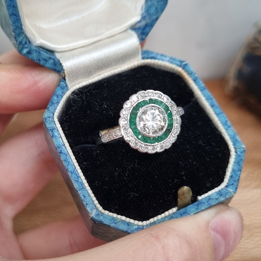Art Deco 1ct Diamond and Emerald Target Cluster Engagement Ring in Platinum, 1.07ct diamond surrounded by calibre emeralds within outer row of diamonds