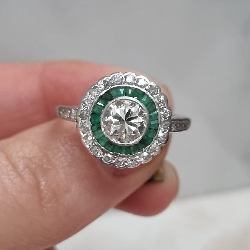 Art Deco 1ct Diamond and Emerald Target Cluster Engagement Ring in Platinum, 1.07ct diamond surrounded by calibre emeralds within outer row of diamonds