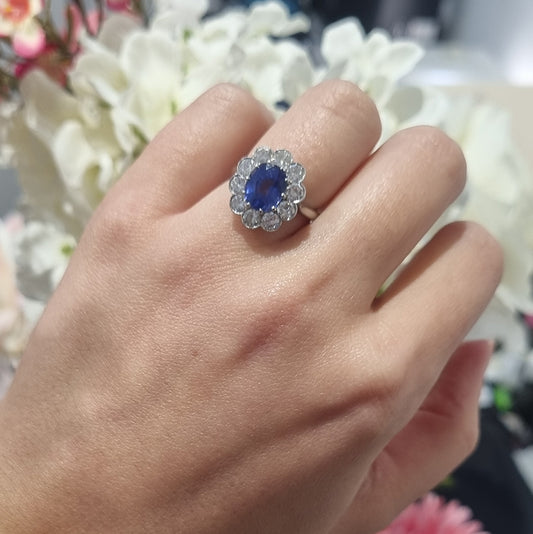 Vintage 2ct Cornflower Blue Sapphire and Diamond Cluster Engagement Ring in Platinum, 2.12ct oval-cut cornflower blue sapphire surrounded by 1ct of sparkling round brilliant-cut diamonds