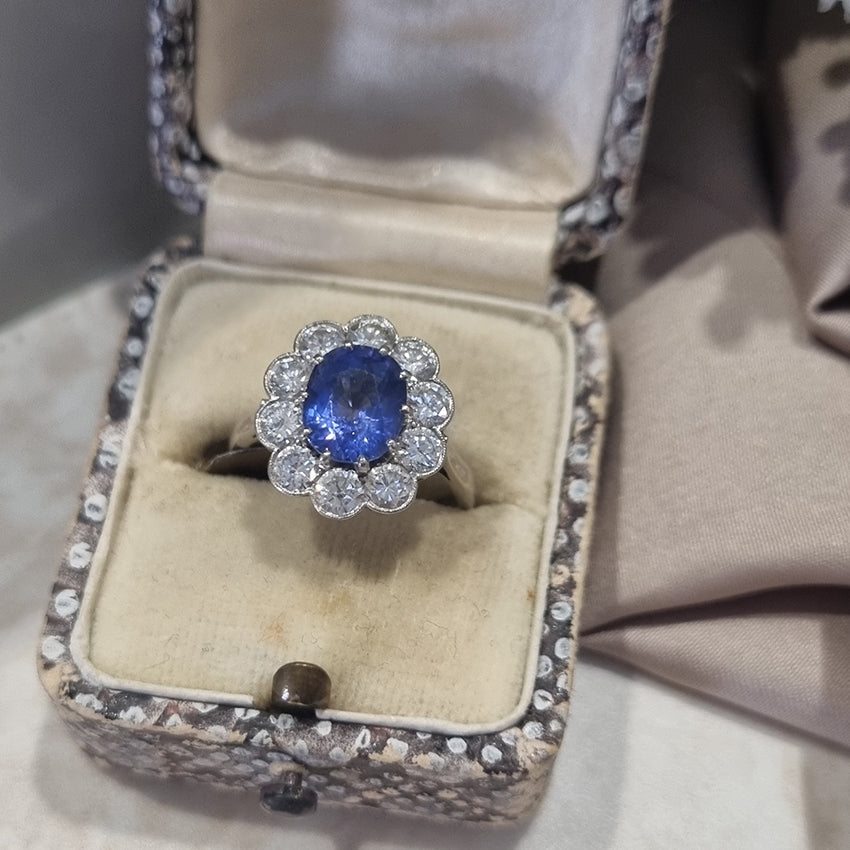 Vintage 2ct Cornflower Blue Sapphire and Diamond Cluster Engagement Ring in Platinum, 2.12ct oval-cut cornflower blue sapphire surrounded by 1ct of sparkling round brilliant-cut diamonds