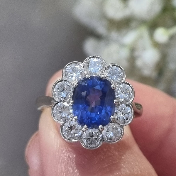 Vintage Cornflower Blue 2ct Sapphire and Diamond Cluster Engagement Ring in Platinum, 2.12ct oval-cut cornflower blue sapphire surrounded by 1ct of sparkling round brilliant-cut diamonds