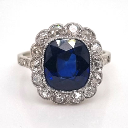 Art Deco 3ct Natural No Heat Sapphire and Diamond Cluster Engagement Ring, 3ct cushion-shaped natural sapphire with no heat treatment surrounded by sparkling diamonds in platinum with millegrain edging