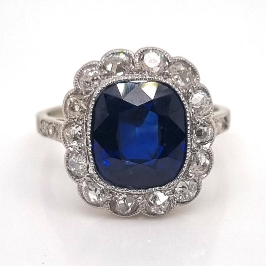 Art Deco 3ct Natural No Heat Sapphire and Diamond Cluster Engagement Ring, 3ct cushion-shaped natural sapphire with no heat treatment surrounded by sparkling diamonds in platinum with millegrain edging