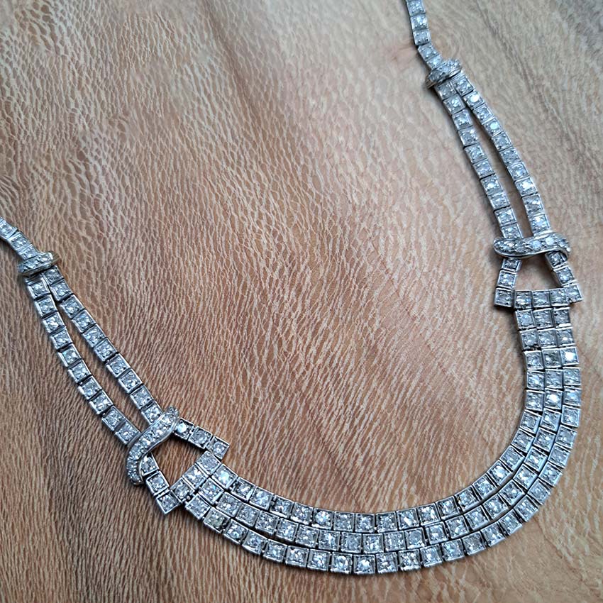 Antique Art Deco 7.64ct Diamond Collar Necklace in Platinum, single-cut and eight-cut diamonds in individual square articulated settings with central three row section graduated to a two row and single row of diamonds with geometric buckle shaped link sections