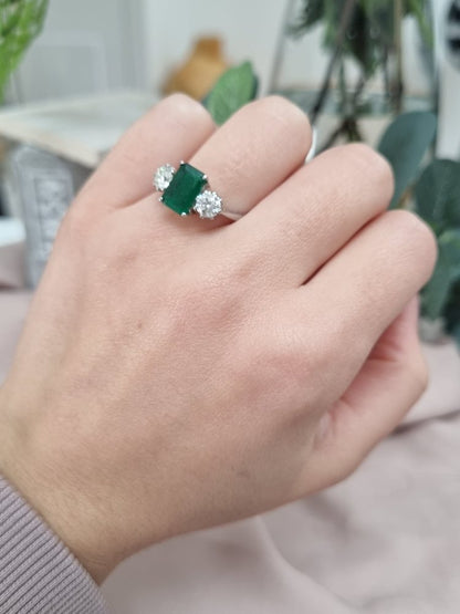 Emerald Cut Emerald and Diamond Three Stone Ring in 18ct White Gold