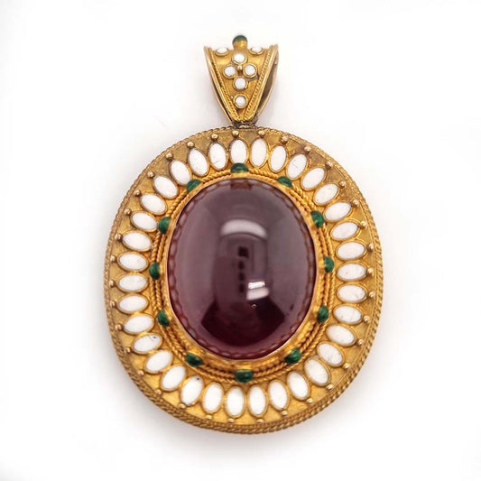 Antique Archaeological Revival Garnet Enamel and Gold Pendant, yellow gold pendant with large oval cabochon-cut garnet accented with white enamel and green enamel decorated surround