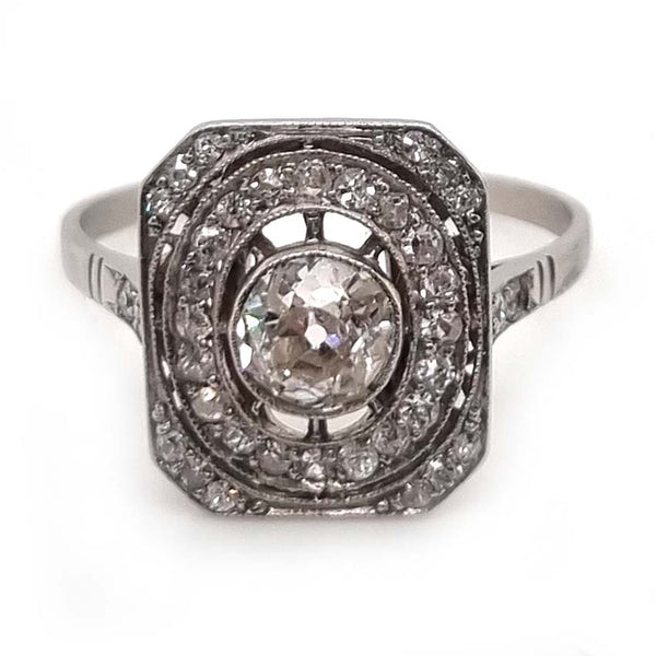 Art Deco Old Cut Diamond Cluster Tablet Plaque Ring, 0.55ct old cut diamond within 0.32ct oval halo and diamond set cut corners of an oblong head in platinum. Circa 1920s