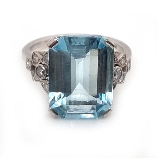 Art Deco 7ct Aquamarine and Diamond Statement Cocktail Ring, 7.12ct emerald-cut aquamarine with geometric diamond shoulders in 18ct white gold. Circa 1930