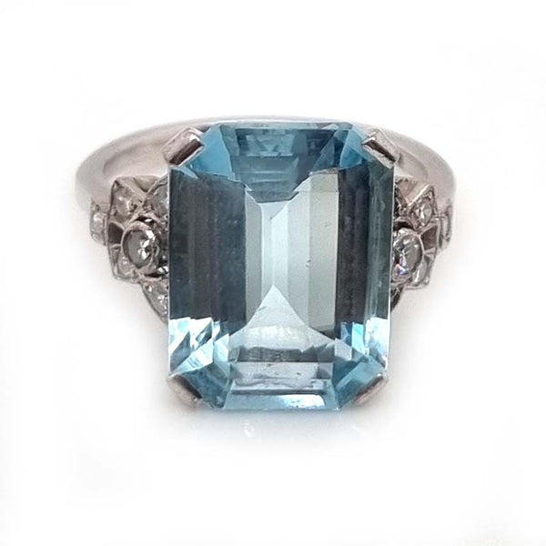 Art Deco 7ct Aquamarine and Diamond Statement Cocktail Ring, 7.12ct emerald-cut aquamarine with geometric diamond shoulders in 18ct white gold. Circa 1930