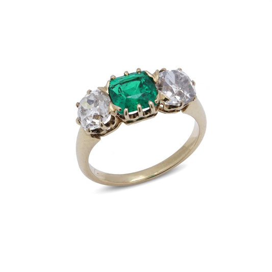 Antique emerald and diamond three-stone ring in gold.