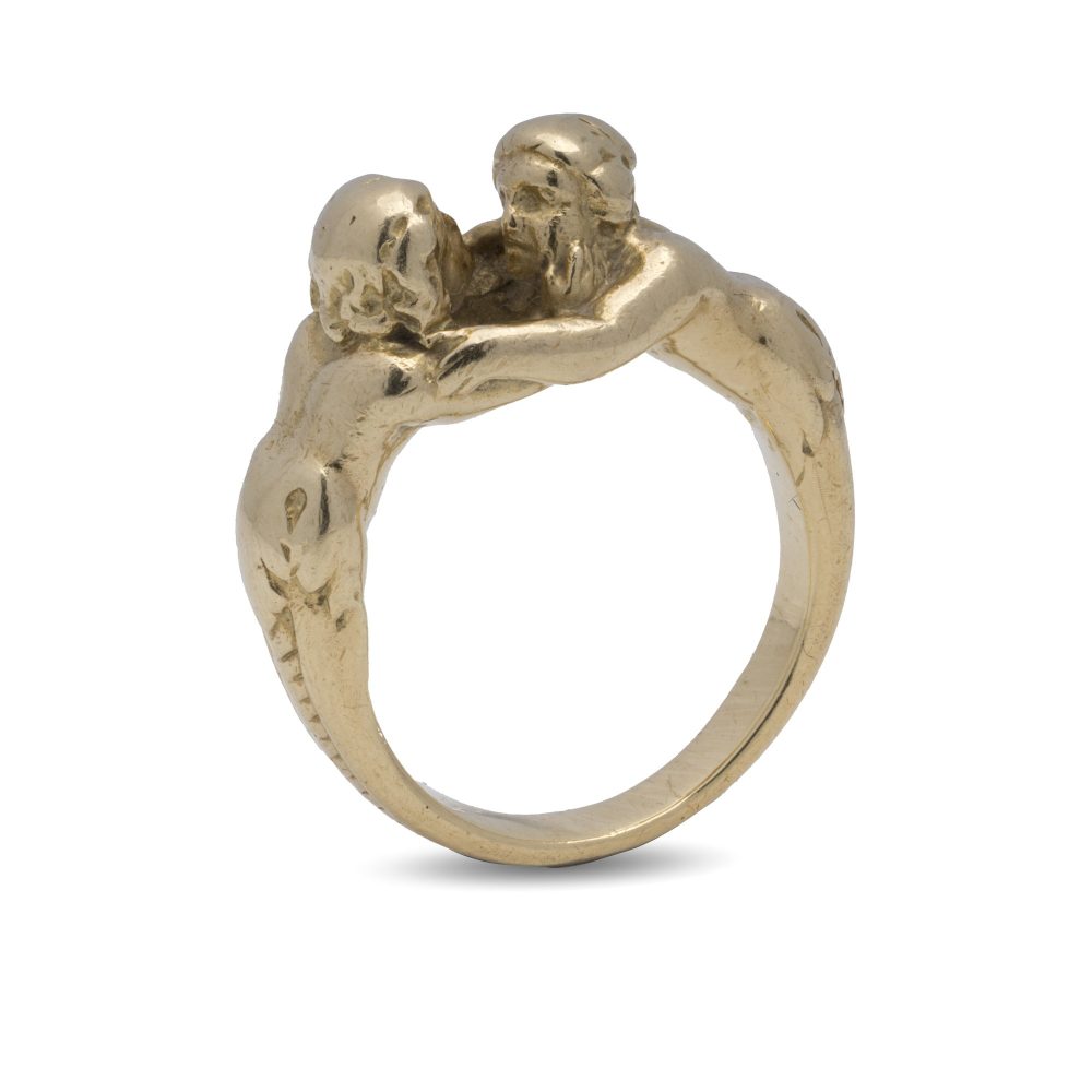 Antique gold ring with man and woman embracing.