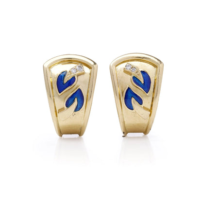 A pair of yellow gold earrings with blue enamel leaves and round diamonds, on a white background