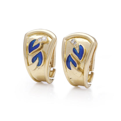 A pair of yellow gold earrings with blue enamel leaves and round diamonds, on a white background
