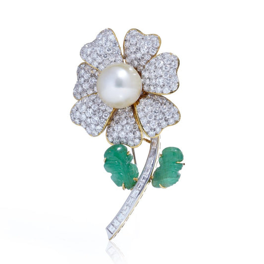 Floral brooch with pearl, diamonds and emeralds in gold.