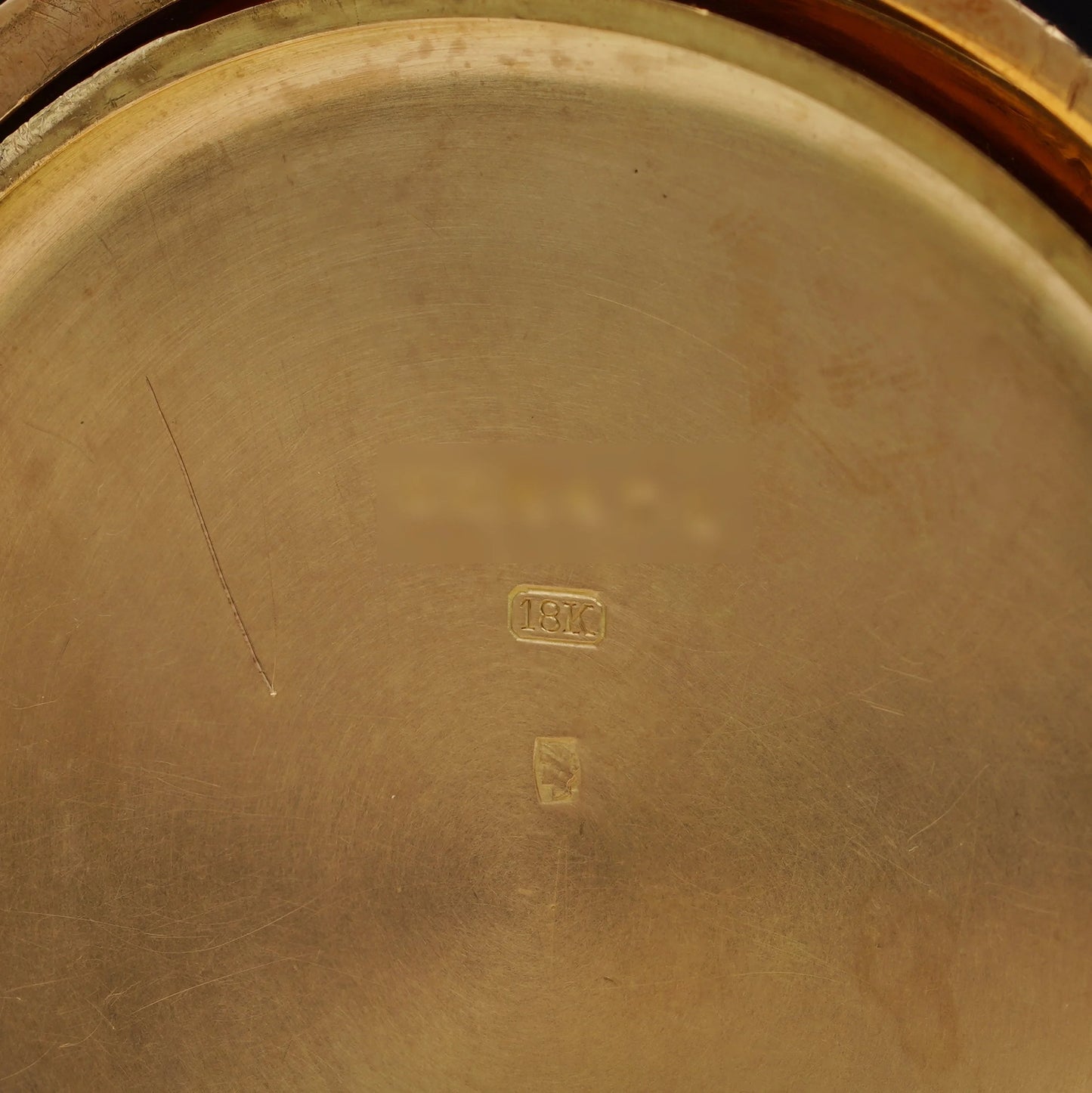 An 18C stamp inside a yellow gold case