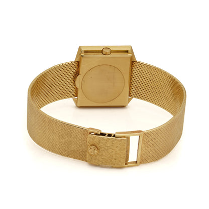 A yellow gold wristwatch with integrated bracelet, on a white background