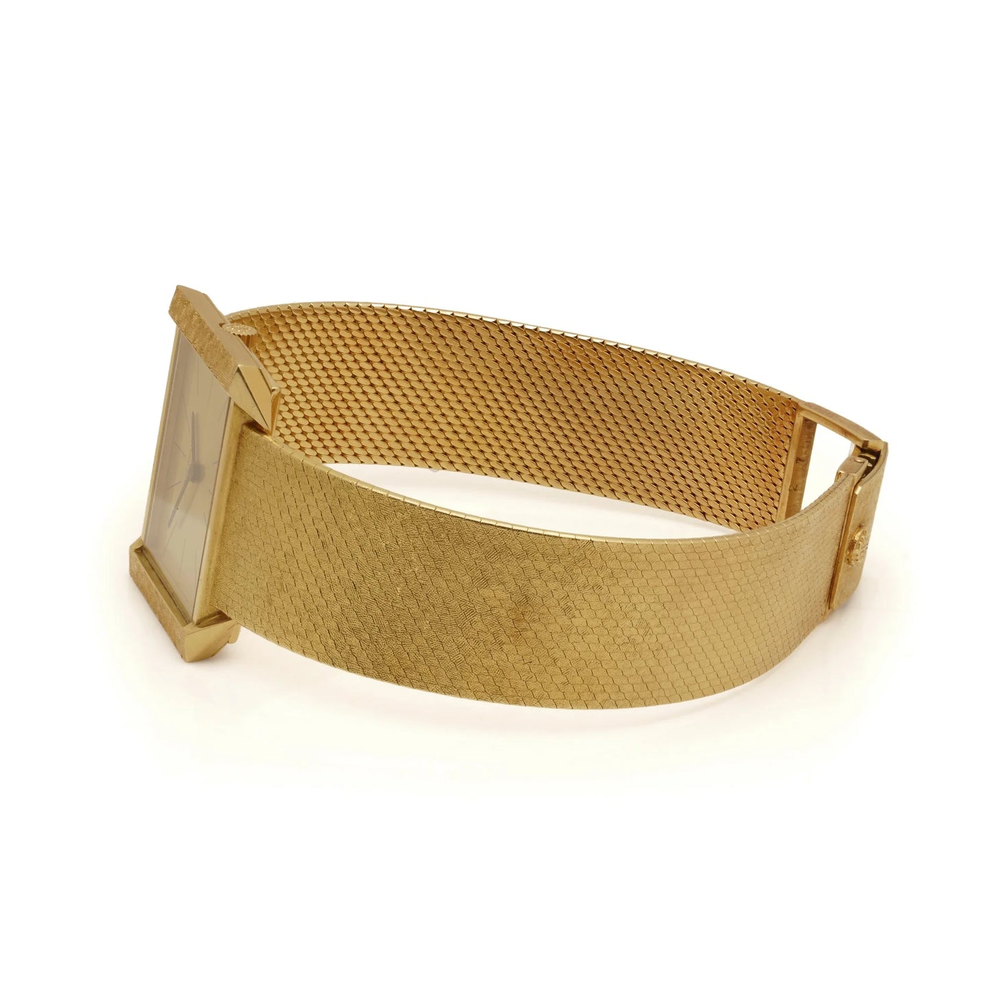A yellow gold Patek Phillipe wristwatch with integrated bracelet, on a white background