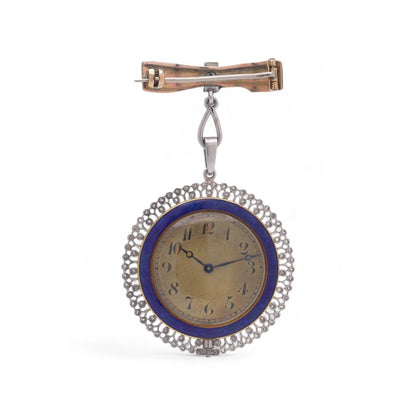 A blue enamel pendant pocket watch in silver with diamonds, suspended by a bow brooch fitting, on a white background