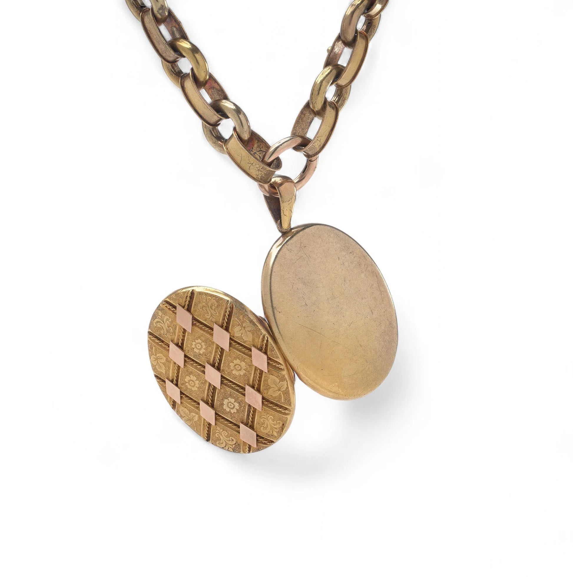 An antique yellow and rose gold fancy link necklace with an oval locket pendant, on a white background