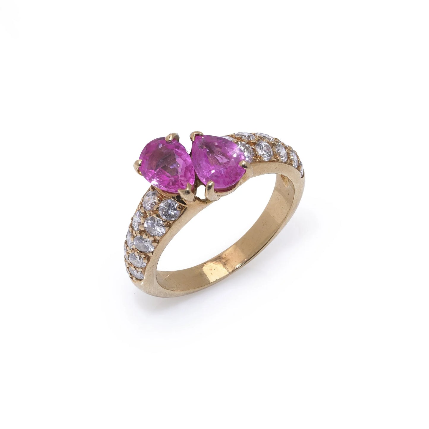 A yellow gold ring with pear shaped pink sapphires and round diamonds, on a white background