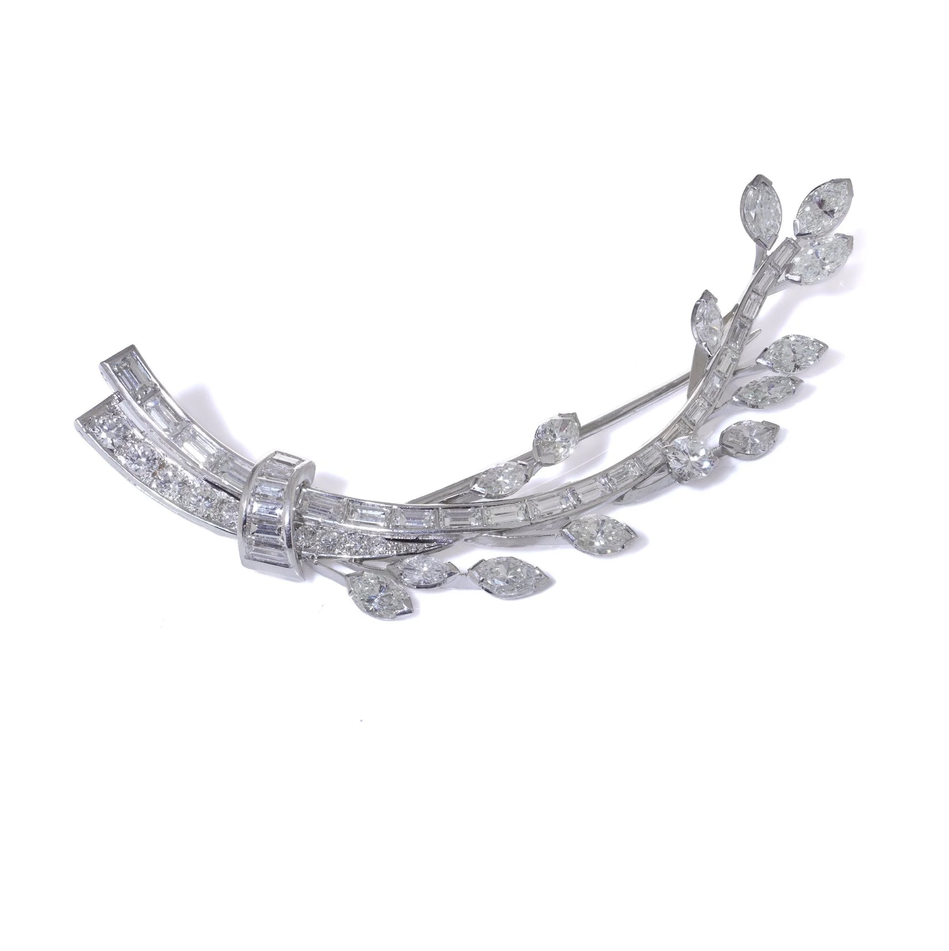 A leaf design brooch set with baguette, marquise and brilliant cut diamonds in white metal, on a white background