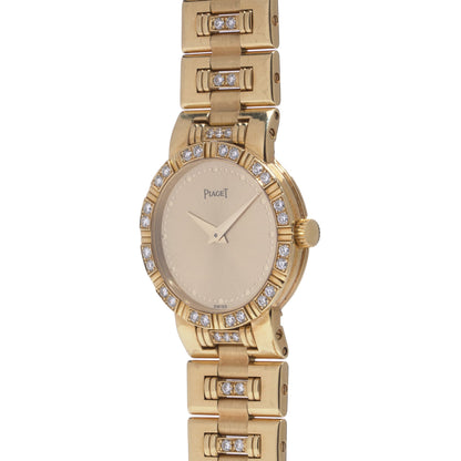 A ladies Piaget yellow gold and diamond wristwatch with champagne coloured dial, on a white background